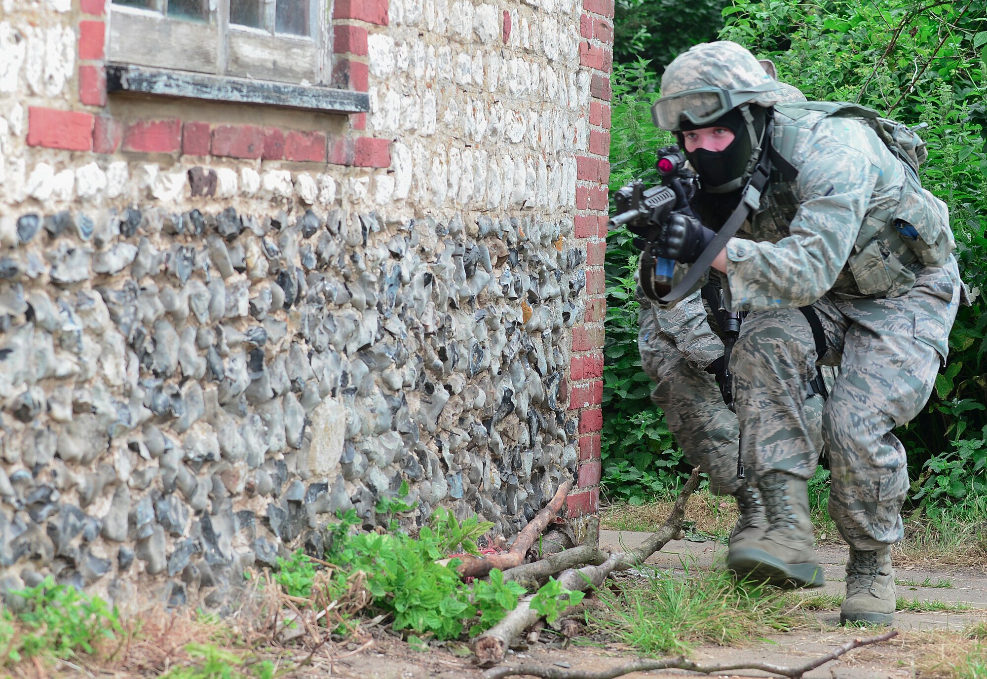 STANFORD TRAINING AREA, England – Airman Austin Chipman, 48th Security Force Squadron response force member, prepares to clear a house while running a domestic violence scenario during force-on-force training at the Stanford Training Area in Norfolk, July 11, 2013. Members from the 48th SFS conducted a three-day training exercise at STANTA, an area that offers a realistic environment to help train Airmen. Defenders from the 100th SFS, RAF Mildenhall, assisted this training by playing as opposing forces. (U.S. Air Force photo by Airman 1st Class Dana J. Butler) 