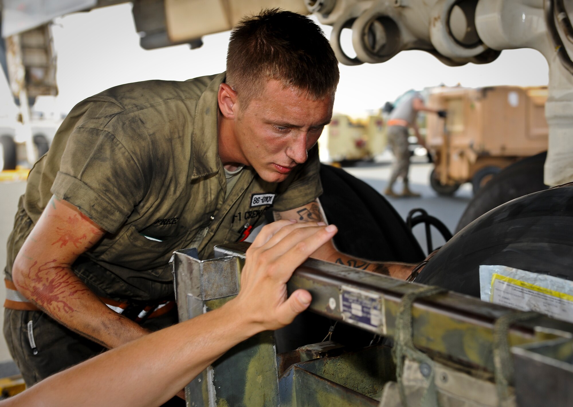 Senior Airman Joshua Free repairs a blown tire on a B-1B Lancer at the 379th Air Expeditionary Wing in Southwest Asia, July 15, 2013. Free is a 34th Aircraft Maintenance Unit B-1 crew chief deployed from Ellsworth Air Force Base, S.D. (U.S. Air Force photo/Senior Airman Benjamin Stratton)