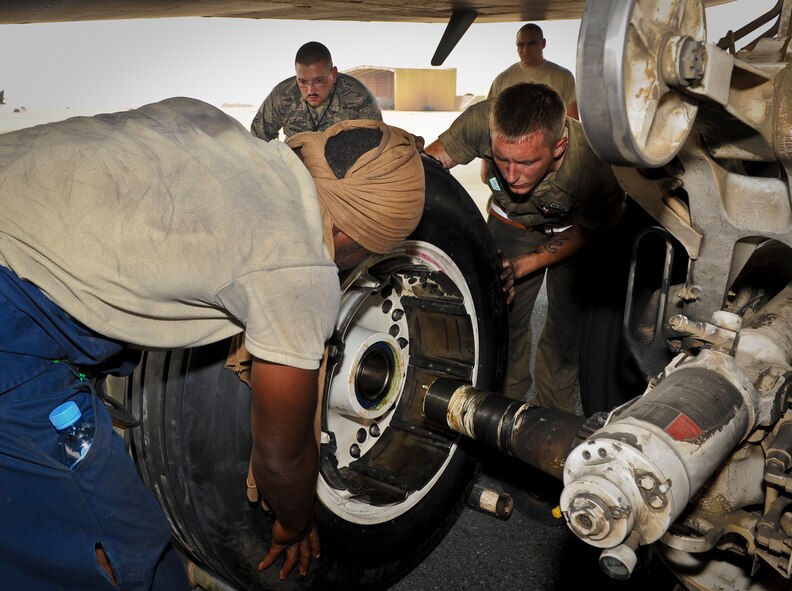 B-1B Lancer crew chiefs from the 34th Aircraft Maintenance Unit work to fix a blown tire as Tech. Sgt. Jeffrey Bailey ensures the work is completed following safety guidelines contained within their technical orders at the 379th Air Expeditionary Wing in Southwest Asia, July 15, 2013. Bailey is a 379th Expeditionary Maintenance Group quality assurance inspector deployed from Mountain Home Air Force Base, Idaho, and these crew chiefs are deployed from Ellsworth Air Force Base, S.D. (U.S. Air Force photo/Senior Airman Benjamin Stratton)