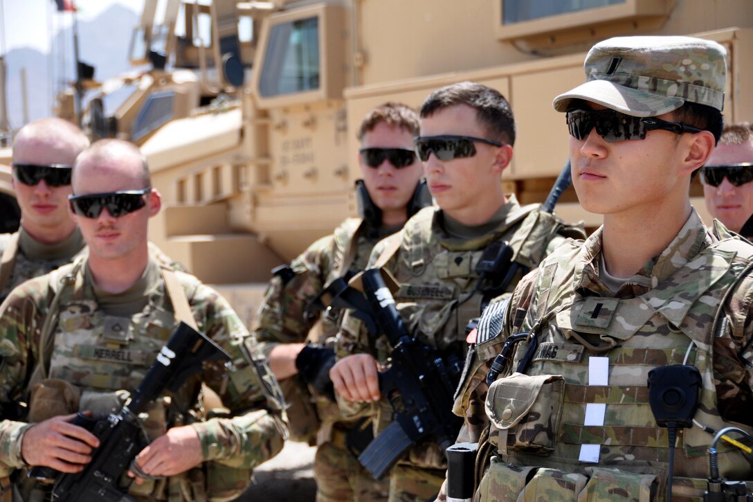 U.S. Army 1st Lt. Eugene Kwag, right, debriefs his team members after returning to Forward Operating Base Farah from a mission in Farah City, Afghanistan, July 17, 2013. Kwag, a member of Provincial Reconstruction Team Farah, is assigned to 2nd Battalion, 12th Field Artillery Security Force.
