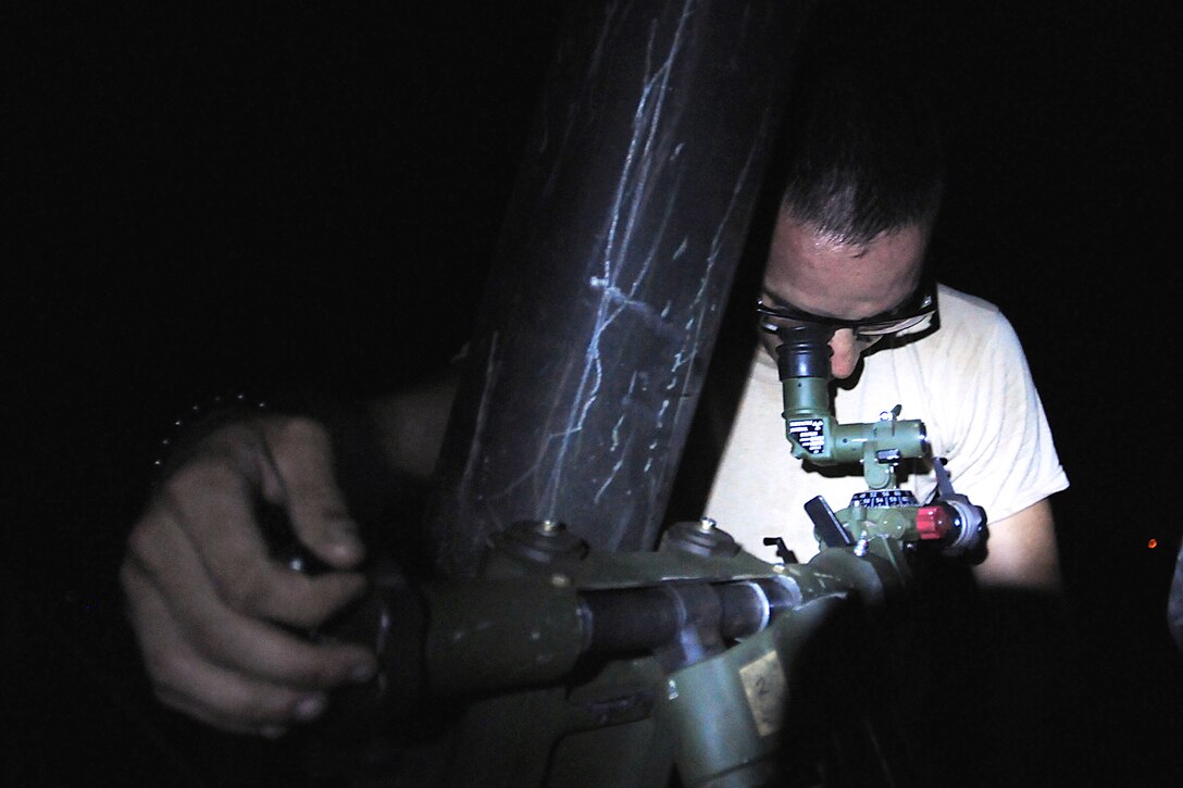 Army Pfc. Juan Carlos Rivera adjusts the deflection and elevation of a round for a 120mm illumination mortar system during a night training mission on Camp Santiago Joint Maneuver Training Center in Salinas, Puerto Rico, July 14, 2013. Rivera, an infantryman, is assigned to the Puerto Rico National Guard's Headquarters Company, 1st Battalion, 296th Infantry Regiment, 101st Troop Command.