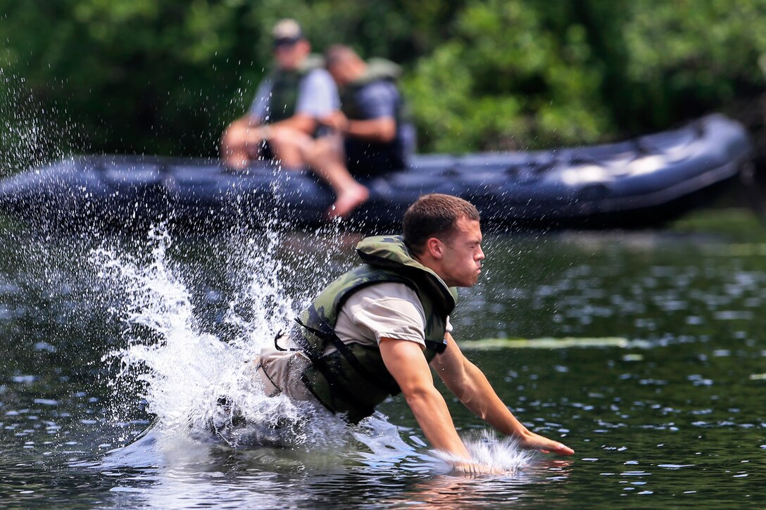 An Army cadet splashes into the water after releasing from a cable during a field training exercise on Camp Buckner at the U.S. Military Academy at West Point, N.Y., July 10, 2013.