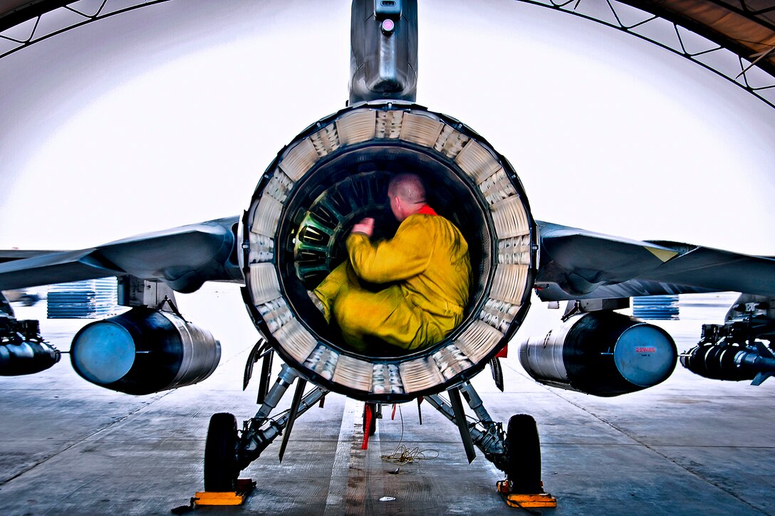 U.S. Air Force Senior Airman Nate Hall conducts a post-flight inspection on an F-16 Fighting Falcon aircraft on Kandahar Airfield, Afghanistan, July 5, 2013. Hall, an aircraft maintainer assigned to the 451st Expeditionary Aircraft Maintenance Squadron, inspects aircraft for leaks, cracks or anything that may jeopardize the integrity of the aircraft.
