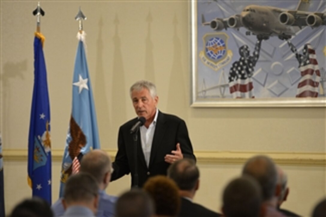 Secretary of Defense Chuck Hagel answers a question from the audience as he conducts a town hall meeting with civilian employees and service members at Joint Base Charleston in Charleston, S.C., on July 17, 2013.  Hagel is visiting base to conduct town hall meetings and receive briefings from Air Force and civilian leaders on the impact of furloughs and sequestration on their lives and operations.  