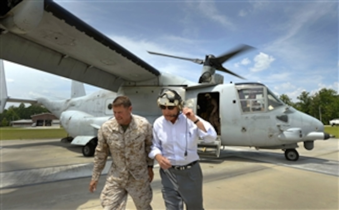 Marine Major Gen. Mark Clark, left, escorts Secretary of Defense Chuck Hagel, right, from a Marine Corps V-22 Osprey as he arrives at Camp Lejeune, N.C., on July 17, 2013.  Hagel is visiting Marine units in the Jacksonville, N.C., area to conduct town hall meetings and receive briefings from Marine Corp and civilian leaders on the impact of furloughs and sequestration on their lives and operations.  