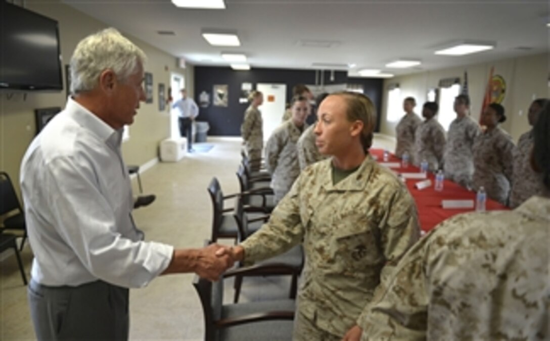 Secretary of Defense Chuck Hagel walks around the table to introduce himself to a group of women Marines at Camp Lejeune, N.C., on July 17, 2013.  Hagel will conduct a roundtable discussion on Women in Combat with the women Marines.  Hagel is visiting Marine units in the Jacksonville, N.C., area to conduct roundtable discussions, town hall meetings, and receive briefings from Marine Corp and civilian leaders on the impact of furloughs and sequestration on their lives and operations.  