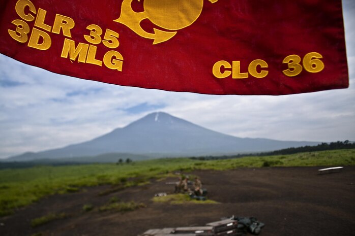 The Combat Logistics Company 36 guidon stands on a range located on Combined Arms Training Center Camp Fuji, underneath Mt. Fuji during Exercise Dragon Fire 2013, July 12. Dragon Fire 13 is CLC-36’s annual Battle Skills Training exercise that focuses on improving individual and collective combat skills of CLC-36 Marines and sailors with an emphasis on weapons familiarization training.