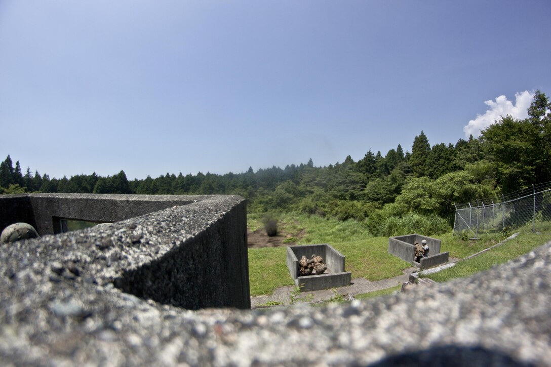 Servicemembers duck as a grenade explodes during a training exercise located on a grenade range at Combined Arms Training Center Camp Fuji during Exercise Dragon Fire 2013, July 10. Training participants started training by rehearsing throwing techniques, then moved on to using the M-69 practice grenade, commonly known as a “blue body.”
