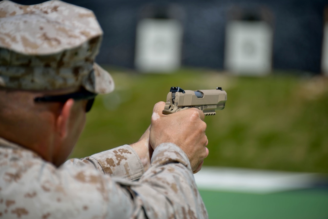 A Marine with Force Reconnaissance Company, 3rd Recon. Battalion, sights in an M45A1 close-quarters battle pistol during training June 3 at Range 15 near Camp Hansen. The Marines applied the fundamentals of marksmanship they learned in recruit training, including proper sight alignment and sight picture. 3rd Recon Bn. is a part of 3rd Marine Division, III Marine Expeditionary Force. (U.S. Marine Corps photo by Cpl. Mark W. Stroud/Released)