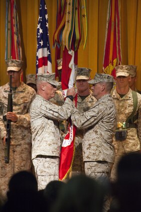Maj. Gen. H. Stacy Clardy III, left, receives the 3rd Marine Division organizational colors from Maj. Gen. Frederick M. Padilla, right, during a change of command ceremony July 12 at the Camp Courtney theater. Padilla’s next command will be at Headquarters, U.S. Marine Corps where he will serve as the Director of Operations with Plans, Policies and Operations. Clardy’s previous assignment was at Headquarters, U.S. Marine Corps where he served as the Director of Operations with Plans, Policies and Operations. The division is a part of III Marine Expeditionary Force. (U.S. Marine Corps photo by Sgt. Brian A. Marion/Released)