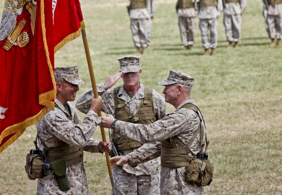 Lt. Gen. Kenneth J. Glueck Jr., right, passes the III Marine Expeditionary Force organizational colors to Lt. Gen. John E. Wissler during the III MEF change of command ceremony July 19 on Camp Foster. “To our Marines and sailors, you are a certain force in an uncertain world,” said Glueck during his farewell address. “Thanks to your unfailing leadership and commitment, III MEF will remain our nation's force of choice in the Pacific. It has been my distinct honor to serve as your commanding general and be part of this tremendous team.” (Official U.S. Marine Corps photo by Sgt. Brian A. Marion/Released)