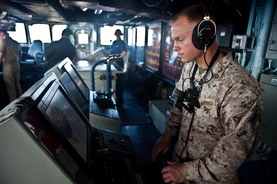 Staff Sgt. Michael W. Burkhart, an amphibious assault vehicle section leader with Company G., Battalion Landing Team 2nd Battalion, 4th Marines, 31st Marine Expeditionary Unit, and native of Norman, Okla., alters the ship’s course heading here, July 15. Burkhart is training to be a qualified helmsman of small-deck Navy vessels in addition to performing his duties as an AAV staff noncommissioned officer in support of a bilateral exercise in Australia. The 31st MEU is embarked aboard the Bonhomme Richard Amphibious Ready Group, currently participating in Talisman Saber 2013,a biennial training exercise with the Australian military designed to enhance multilateral collaboration in support of future combined operations, natural disaster, humanitarian and emergency response.