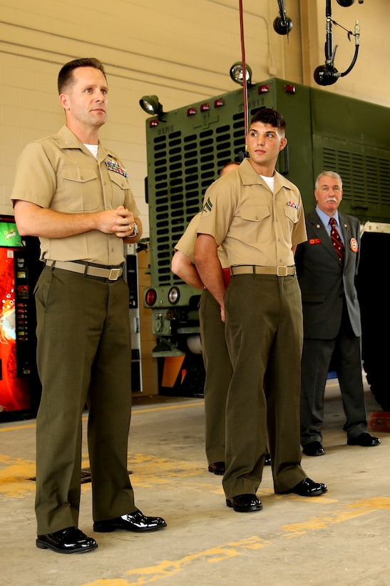 Cpl. Lucas Matte (center), a motor transport technician with Marine Wing Support Squadron 273, stands aside Col. William Lieblein (left), the commanding officer of Marine Aircraft Group 31, during an awards ceremony, July 12, recognizing Matte for his superior performance throughout 2012. Matte was recognized by the Marine Corps Motor Transport as the Motor Transport Technician of the Year for 2012, an award earned by Matte after being selected from a occupational field that contains almost 15,000 Marines.