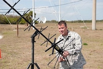 Maj. Larry Skipper, 601st Air and Space Operations Center configuration manager at Tyndall AFB, Fla., adjusts a Joint-Based Expeditionary Connectivity Center antenna at Cape Canaveral AFS, Fla., before the final launch of Space Shuttle Discovery Feb. 24, 2011. JBECC provides a comprehensive air picture to the entire launch team. 