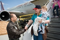 60th Air Mobility Wing commander Col. James Vechery welcomes Melissa Wilds and her children as they arrive at Travis AFB, Calif. Wilds and her children were part of approximately 240 military family members who returned to the U.S. from Japan following the March 11, 2011 earthquake and tsunami that hit the island nation. Wilds' husband is in the U.S. Navy and stationed at Yokosuka Naval Base.
