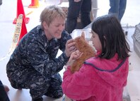 Petty Officer 1st Class Laurie Roods, Navy Operational Support Center Denver, helps Gloria Loveday find her cat after landing at Denver International Airport March 24. Members of all four military branches are working in support of the aerial port of debarkation at DIA as part of Operation Pacific Passage. DIA began receiving military dependents March 24, joining Seattle-Tacoma International Airport, Wash., and Travis Air Force Base, Calif. as points of debarkation for military dependents leaving Japan following the March 11 earthquake and tsunami. 