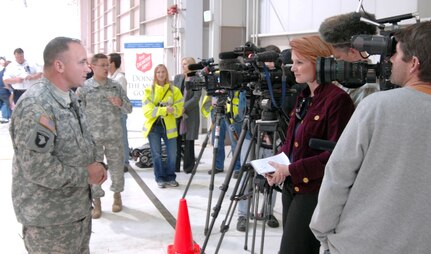 Army Col. Marc Hutson, Defense Coordination Officer for FEMA Region 8, briefs members of the media about flights coming into Denver International Airport from Japan as part of Operation Pacific Passage. DIA received its first flight of 144 people March 24 as part of the voluntary departure of military dependents from Japan following the earthquake and tsunami that struck the country March 11. 