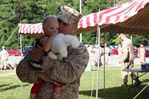 Capt. Michael J. Hilleary, a joint terminal attack controller with Combat Logistics Battalion 6, 2nd Marine Logistics Group, holds his child for one of the last times prior to leaving on a deployment to Afghanistan aboard Camp Lejeune, N.C., July 10, 2013. Marines and sailors parted with loved ones at a family event held immediately before the unit’s departure to Afghanistan.
