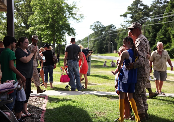 A Marine with Combat Logistics Battalion 6, 2nd Marine Logistics Group has his picture taken with family before leaving on a deployment to Afghanistan aboard Camp Lejeune, N.C., July 10, 2013. Service members were given an opportunity to spend time with family and friends, who saw them off safely on the deployment.