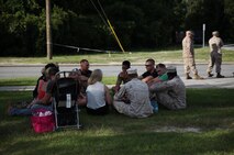 Service members with Combat Logistics Battalion 6, 2nd Marine Logistics Group sit with family and friends one last time before leaving on a deployment to Afghanistan aboard Camp Lejeune, N.C., July 10, 2013. Service members with the battalion gathered with loved ones for several hours before they commenced their logistics support mission to Afghanistan.

