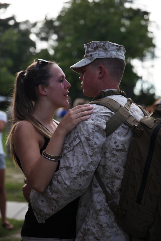 A service member with Combat Logistics Battalion 6, 2nd Marine Logistics Group parts with his sweetheart prior to leaving on a deployment to Afghanistan aboard Camp Lejeune, N.C., July 10, 2013. Service members with CLB-6 parted with loved ones before boarding buses to leave on a half-year deployment in order to provide tactical logistics support to units operating throughout Regional Command Southwest as they continue to advise and assist the Afghan National Security Forces.