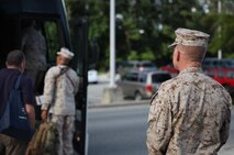 Lt. Col. Brian W. Mullery, the commanding officer of Combat Logistics Battalion 6, 2nd Marine Logistics Group, watches as Marines deploying to Afghanistan with his unit board a bus aboard Camp Lejeune, N.C., July 10, 2013. The battalion spent several months training in preparation for its mission to provide tactical logistics support to units operating throughout Regional Command Southwest as they continue to advise and assist the Afghan National Security Forces.