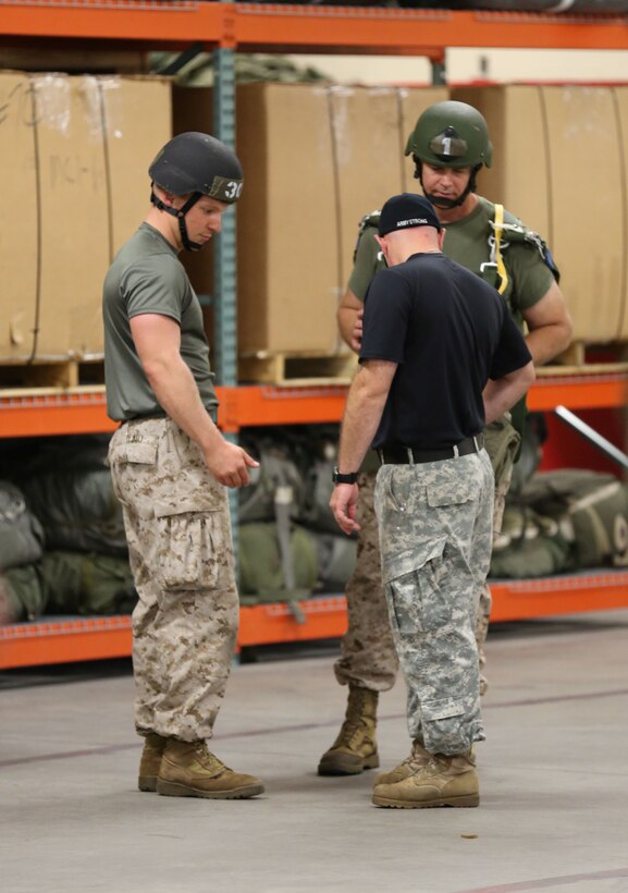 A Jump Master Course Instructor shows Marines what to look for while conducting pre-jump inspections during a course held aboard Camp Lejeune, N.C., July 19, 2013. Before being certified each Marine must inspect three jumpers in a five minute period. (U.S. Marine Corps photo by Lance Cpl. Shawn Valosin)