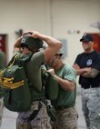 A Jump Master Course Instructor supervises as a Marine inspects a classmate’s parachute, July 19, 2013. Marines from various units throughout the Marine Corps attended the course aboard Camp Lejeune, N.C. (U.S. Marine Corps photo by Lance Cpl. Shawn Valosin)