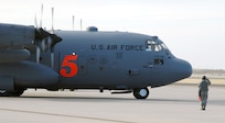 A crew chief with the 302nd Airlift Wing marshals a Modular Airborne Firefighting System-equipped C-130 in preparation for take-off at Peterson Air Force Base, Colo., April 16. Aircraft and crews from the 302nd AW have been assigned to assist the Mexican government in fighting wildland fires in Northern Mexico.  The MAFFS unit, which is owned and maintained by the U.S. Forest Service, is a pressurized self-contained firefighting system designed for installation in C-130 aircraft without structural modifications to the aircraft.  The system is designed to air-drop fire-retardant chemicals onto wildfires.  