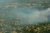 A lead plane from the U.S.D.A. Forest Service guides a C-130, from the 302nd Airlift Wing, Peterson Air Force Base, Colo., toward a wildfire west of Austin, Texas, April 17, 2011.   U.S. Northern Command has deployed six C-130 aircraft equipped with the U.S.D.A. Forest Service’s Modular Airborne Fire Fighting System to support the fight against ongoing wildfires in the area. 