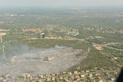 A wildfire burns land near Austin, Texas April 17, 2011. U.S. Northern Command has deployed six C-130 aircraft fitted with the U.S. Forest Service Modular Airborne Fire Fighting System to Texas to support the fight against ongoing wildfires. 