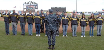 Navy Adm. James Winnefeld, North American Aerospace Defense Command and U.S. Northern Command commander, gives the oath of enlistment to 12 U.S. Navy enlistees at the Sky Sox - Grizzlies game at Security Services Field May 3. The Admiral was also invited to throw out the first pitch.

