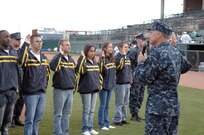 Navy Adm. James Winnefeld, North American Aerospace Defense Command and U.S. Northern Command commander, gives the oath of enlistment to 12 U.S. Navy enlistees at the Sky Sox - Grizzlies game at Security Services Field May 3. The Admiral was also invited to throw out the first pitch. 