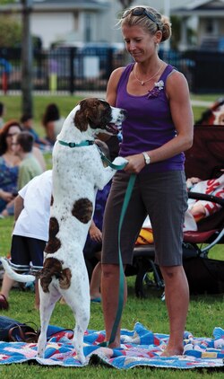 Heidi Goedecke dances with her dog, Lucy, during the U.S. Marine Corps Forces, Pacific Band's second concert in the Summer Concert Series at Mololani Park, July 12, 2013. (U.S. Marine Corps photo by Lance Cpl. Janelle Y. Chapman)