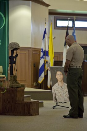 A Marine mourns the loss of Lance Cpl. Levy Rivera during a memorial service at the Chaplain Joseph W. Estabrook Chapel, July 11, 2013. (U.S. Marine Corps photo by Lance Cpl. Janelle Y. Chapman)