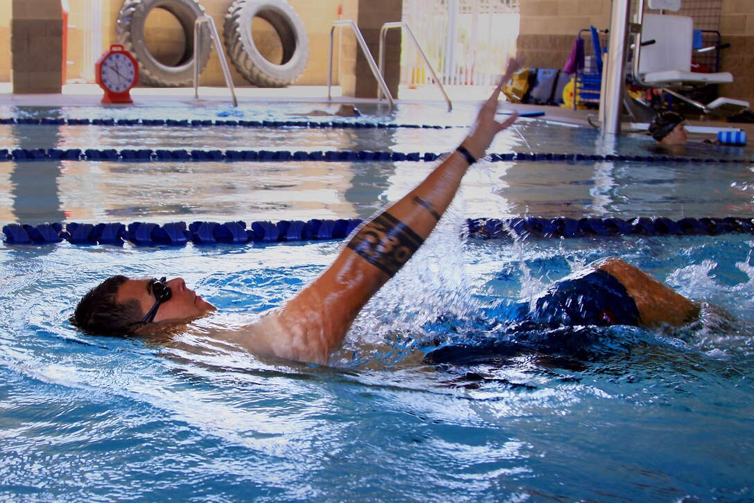 Sgt. Dominic Thiemann, a patient from Wounded Warrior Battalion West, swims during a wounded warrior swim camp here July 18. 