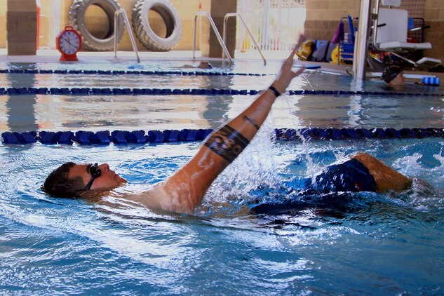 Sgt. Dominic Thiemann, a patient from Wounded Warrior Battalion West, swims during a wounded warrior swim camp here July 18. 