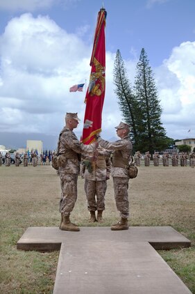 Incoming commanding officer Col. Timothy Winand (left), receives the 3rd Marine Regiment’s colors from outgoing commanding officer Col. Nathan Nastase, symbolizing the exchange of command during 3rd Marine Regiment’s change of command ceremony, July 17, 2013. (U.S. Marine Corps photo by Lance Cpl. Nathan Knapke)