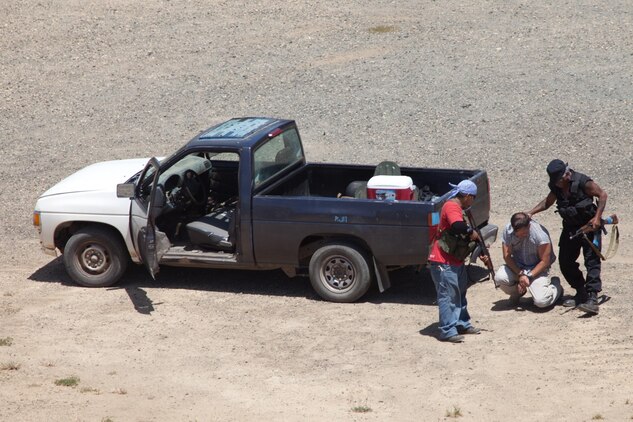Role players act out scenarios for the 4th Force Reconnaissance Company Marines to use for training during two weeks of annual training at the Marine Corps Training Area Bellows, Hawaii, July 18, 2013. (U.S. Marine Corps photo by Lance Cpl. Nathan Knapke)