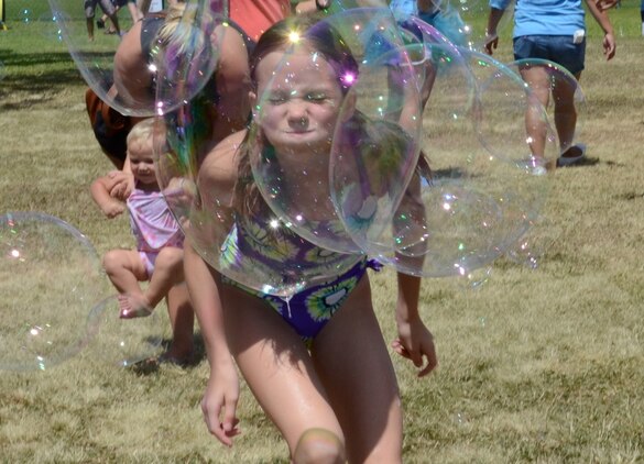 Madison Frazier, 11, runs headlong into a bubble during the Summer Splashdown at Riseley Field, July 13, 2013. Marine Corps Base Hawaii families engaged in numerous water activities at the event. (U.S. Marine Corps photo by Kristen Wong)