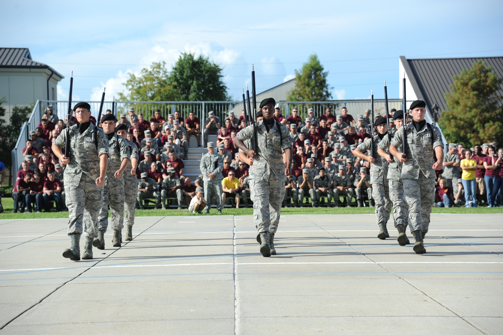 Members of the 338th Training Squadron enter the field of freestyle drill competition during the 81st Training Group drill down competition July 19, 2013, behind the Levitow Training Support Facility, Keesler Air Force Base, Miss.  The 338th TRS won second place in every category to include open ranks, regulation, freestyle and overall.  (U.S. Air Force photo by Kemberly Groue)
