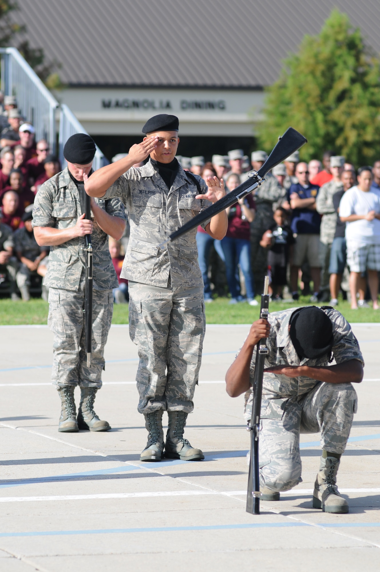 Airman 1st Class Christopher Defilippis, 338th Training Squadron freestyle drill master, spins a rifle while asking permission to exit the field of freestyle drill competition during the 81st Training Group drill down competition July 19, 2013, behind the Levitow Training Support Facility, Keesler Air Force Base, Miss.  The 338th TRS won second place in every category to include open ranks, regulation, freestyle and overall.  (U.S. Air Force photo by Kemberly Groue)