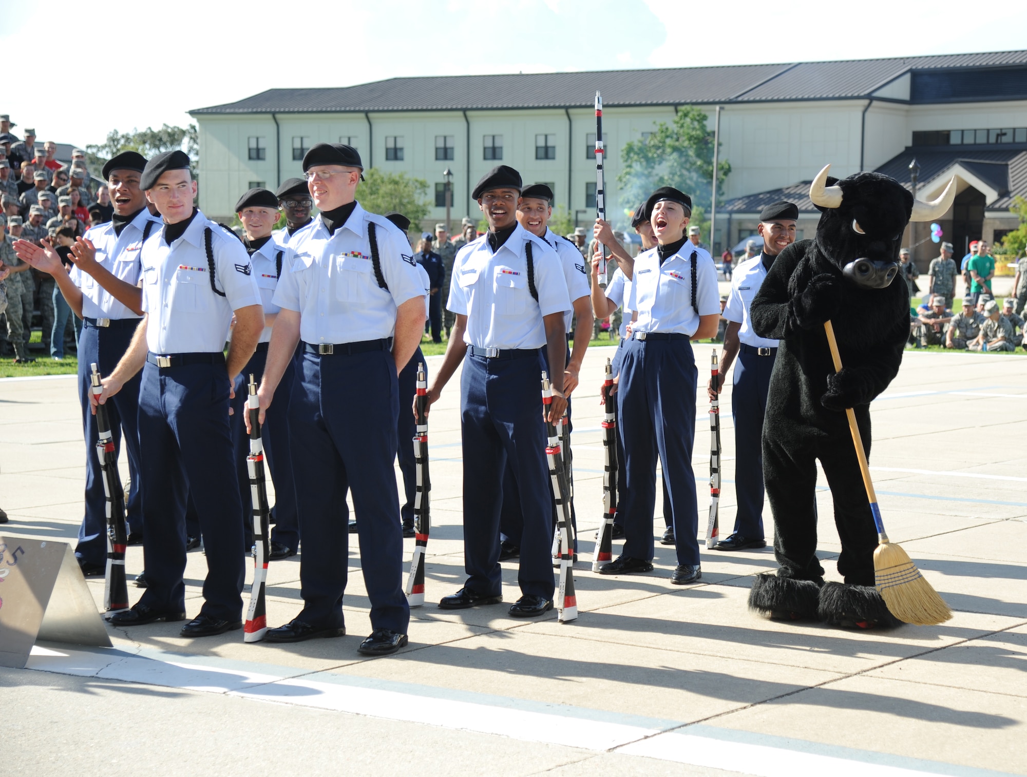 Members of the 335th Training Squadron drill teams cheer as their mascot “sweeps” following the announcement of winners during the 81st Training Group drill down competition July 19, 2013, behind the Levitow Training Support Facility, Keesler Air Force Base, Miss.  The 335th TRS swept the competition winning, first place in every category to include open ranks, regulation, freestyle and overall.  (U.S. Air Force photo by Kemberly Groue)