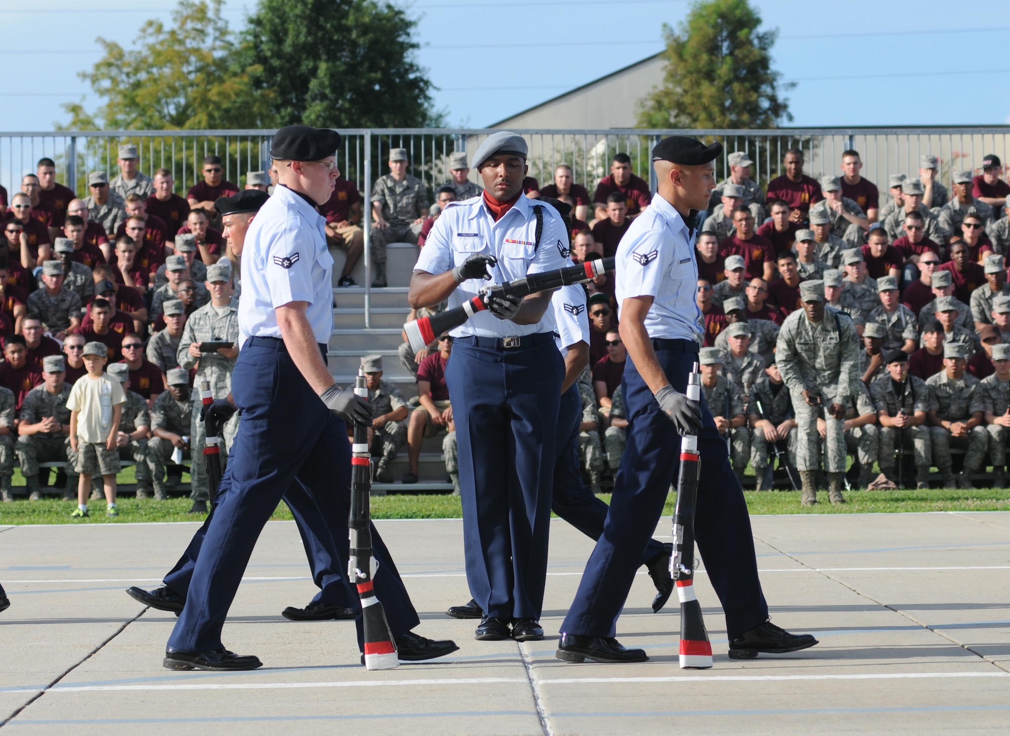 Airman 1st Class David Tolliver, 335th Training Squadron freestyle drill master, spins a rifle in the center of the his fellow Airmen performers during the 81st Training Group drill down competition July 19, 2013, behind the Levitow Training Support Facility, Keesler Air Force Base, Miss.  The 335th TRS swept the competition, winning first place in every category to include open ranks, regulation, freestyle and overall.  (U.S. Air Force photo by Kemberly Groue)