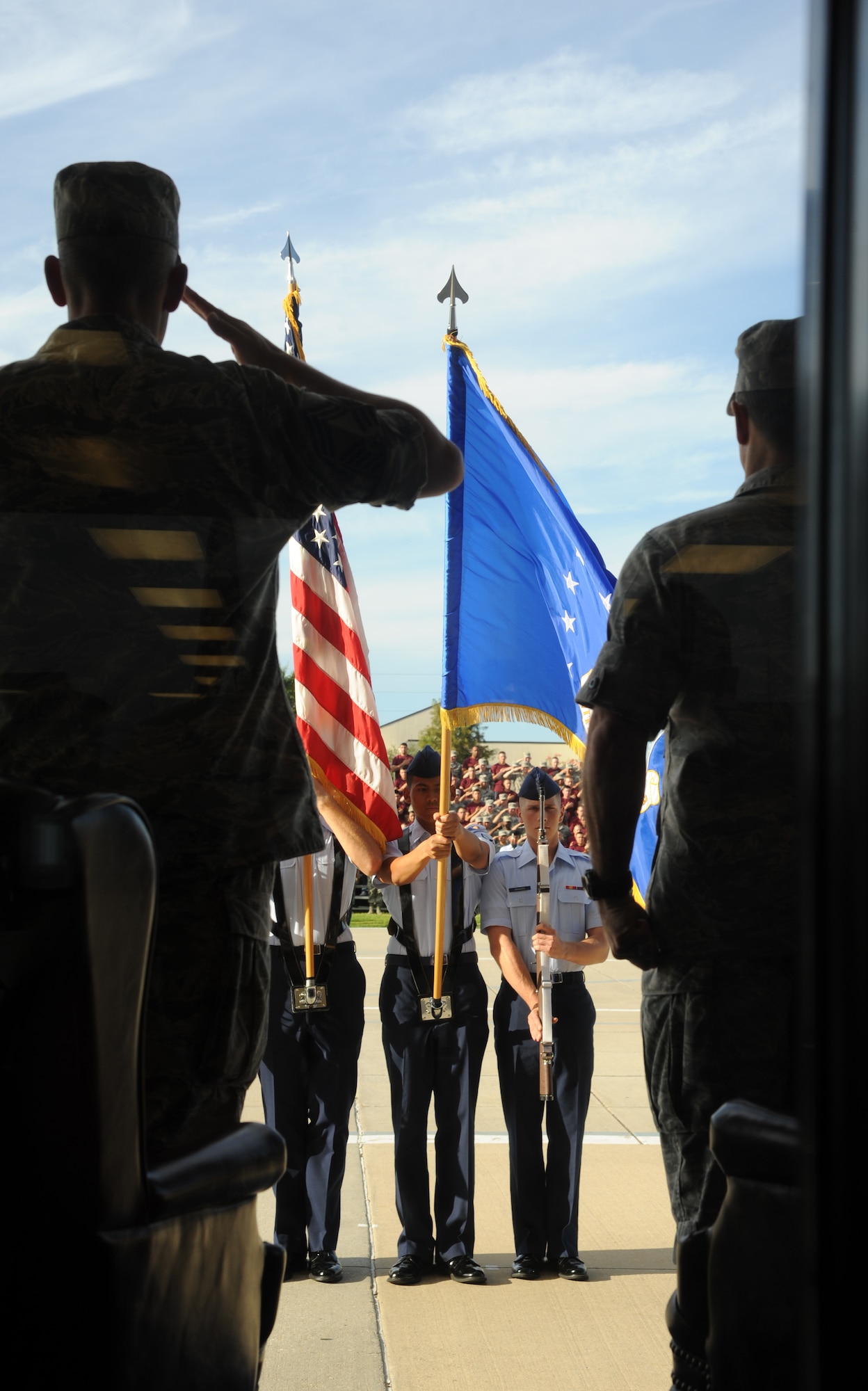 Chief Master Sgt. Robert Winters, 81st Training Group command chief, and Col.  George Tombe, 81st TRG commander, render a salute during the national anthem at the 81st TRG drill down competition July 19, 2013, behind the Levitow Training Support Facility, Keesler Air Force Base, Miss.  Tombe was the presiding officer for the event.  (U.S. Air Force photo by Kemberly Groue)