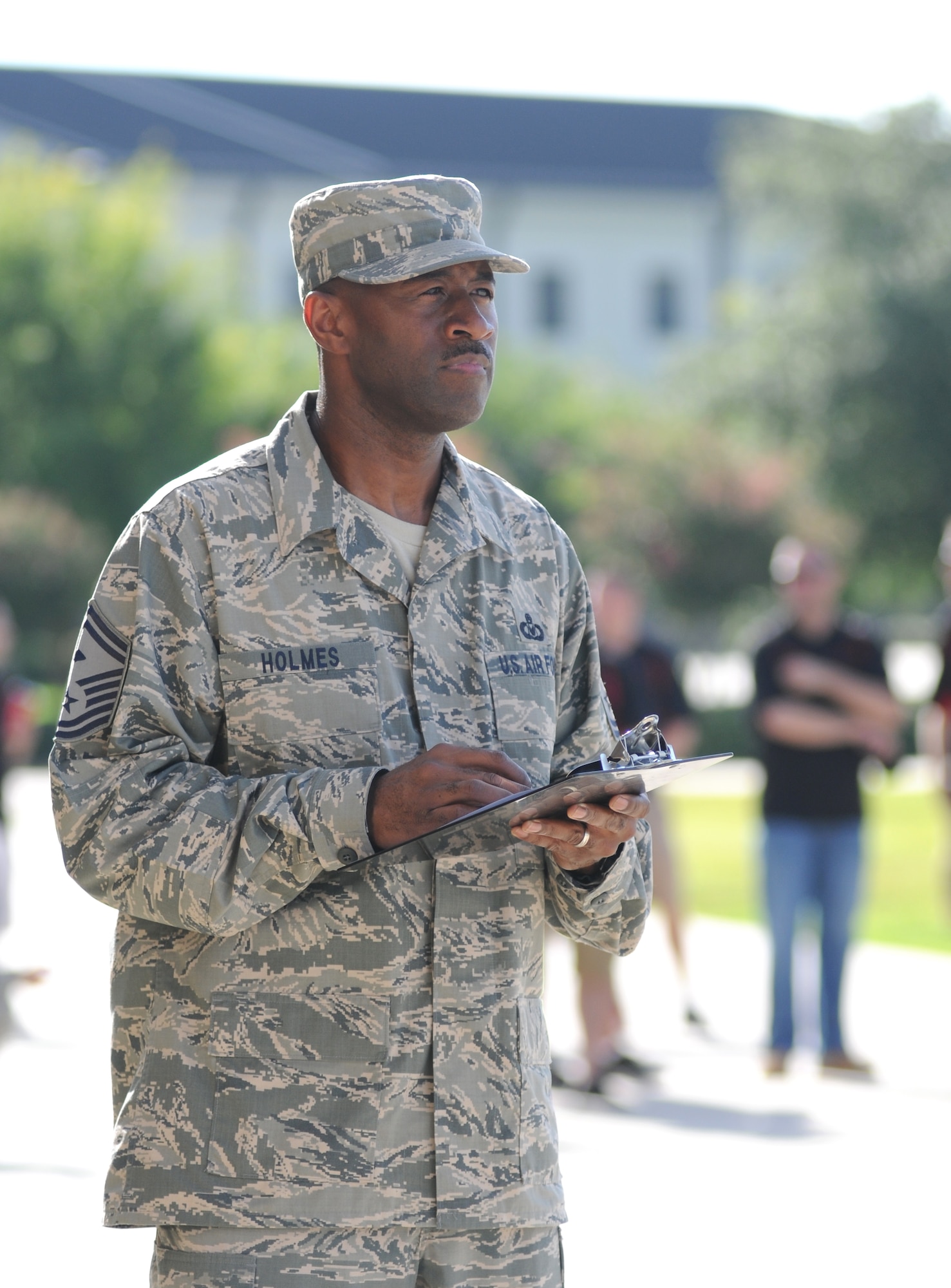 Senior Master Sgt. Kevin Holmes, 338th Training Squadron first sergeant, judges the 81st Training Group drill down competition July 19, 2013, behind the Levitow Training Support Facility, Keesler Air Force Base, Miss.  Col.  George Tombe, 81st TRG commander, was the presiding officer for the event.  (U.S. Air Force photo by Kemberly Groue)