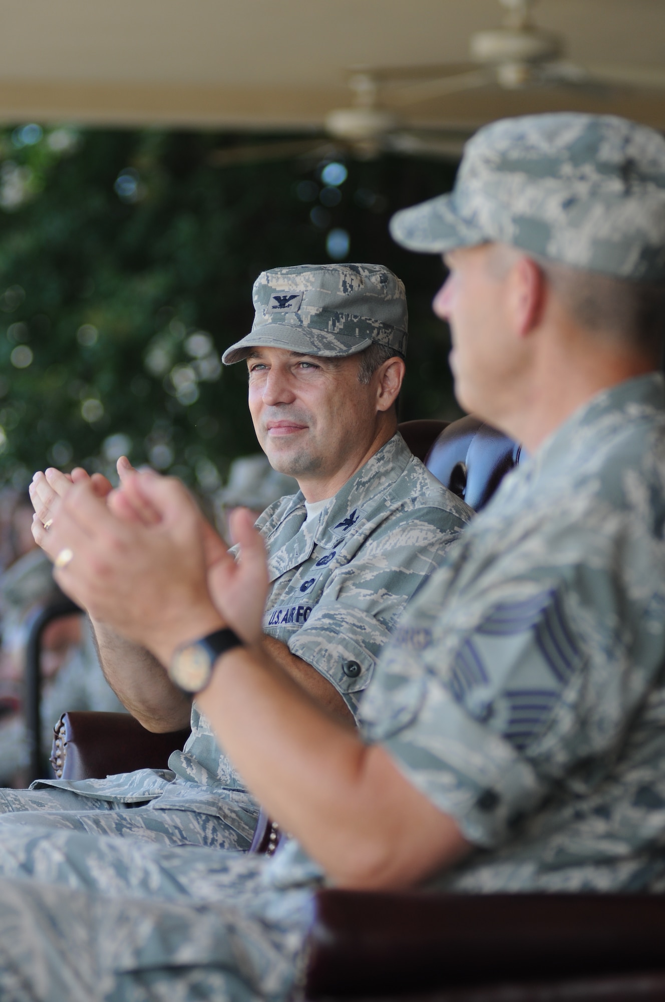 Col.  George Tombe, 81st Training Group commander, and Chief Master Sgt. Robert Winters, 81st TRG command chief, applaud following the introductions of each squadron during the 81st TRG drill down competition July 19, 2013, behind the Levitow Training Support Facility, Keesler Air Force Base, Miss.  Tombe was the presiding officer for the event.  (U.S. Air Force photo by Kemberly Groue)