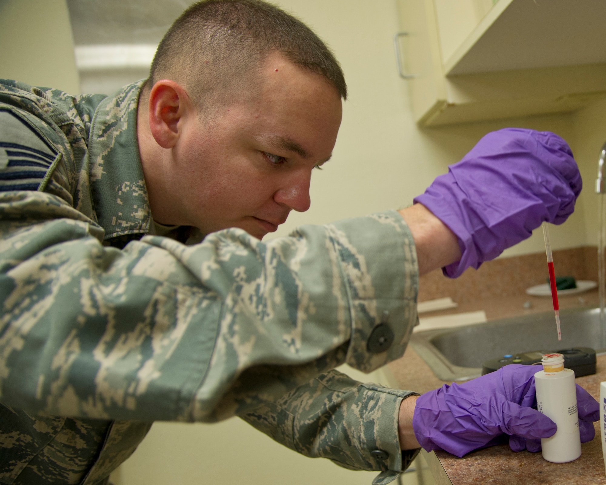 ALTUS AIR FORCE BASE, Okla. – Master Sgt. Kenneth Estes, 97th Medical Operations Squadron NCO in charge of bioenvironmental engineering, prepares to add Phenol Red Solution to a water sample, July 16, 2013 during a routine water sampling. Members of the 97th MDOS bioenvironmental engineering flight routinely monitor for the presence of drinking water contaminants. The base receives its drinking water from the City of Altus water treatment plant. (U.S. Air Force photo by Senior Airman Kenneth W. Norman / Released)