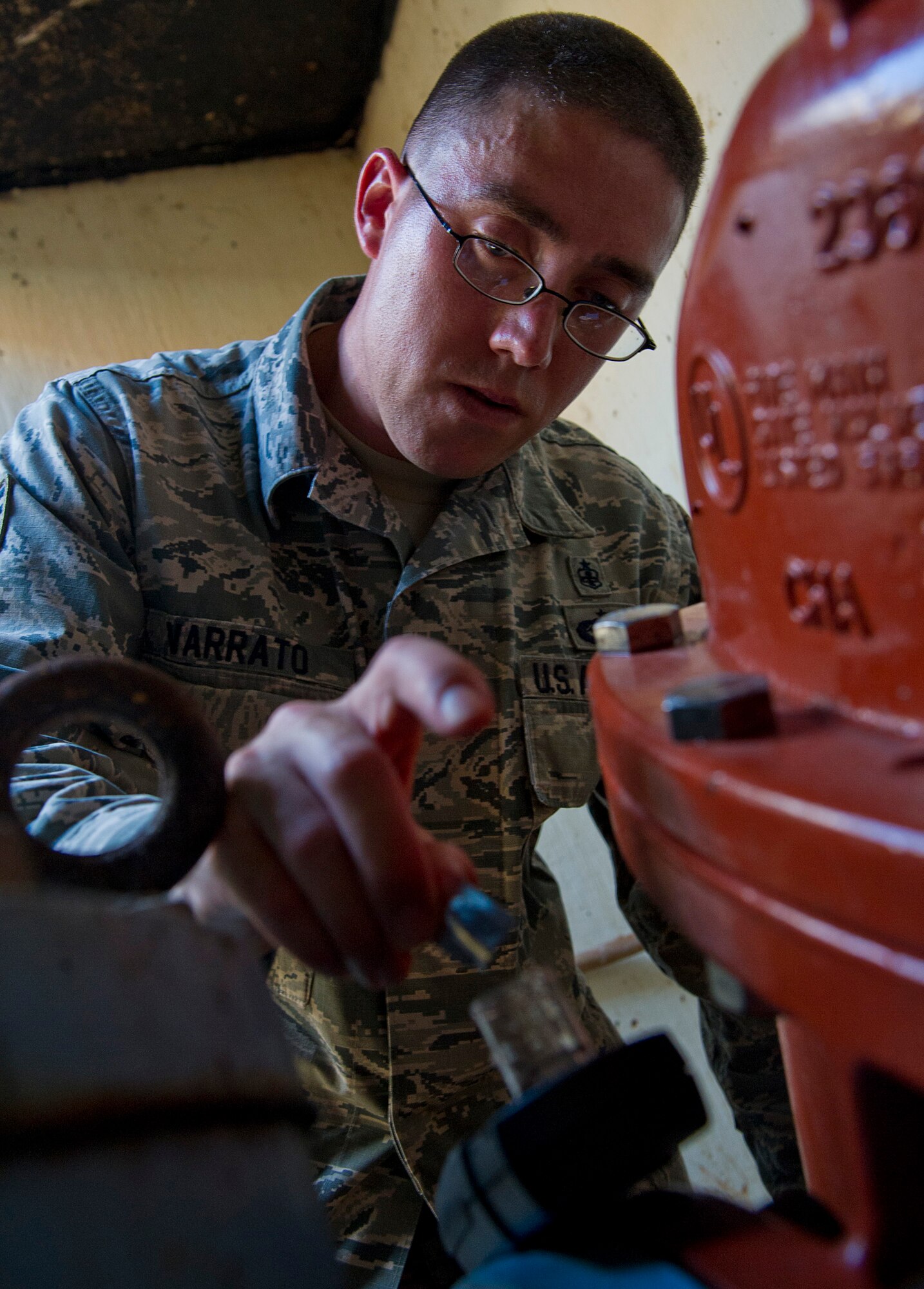 ALTUS AIR FORCE BASE, Okla. -- Staff Sgt. Marshall Varrato, 97th Medical Operations Squadron bioenvironmental engineering NCO in charge of readiness and training, adds a chlorine agent to a water sample during a routine water sampling at the main water line on base. The chlorine agent tests for residual chlorine in the water. Members of the 97th MDOS bioenvironmental engineering flight conduct water samplings twice a month. (U.S. Air Force photo by Senior Airman Kenneth W. Norman / Released)