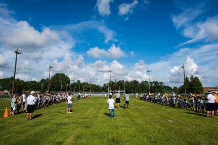 Teams of children line up on the sidelines of the 40 yard dash during the Andre Roberts Pro Camp, July 15, 2013, at Joint Base Charleston - Weapons Station, S.C. More than 100 base children attended the Andre Roberts Pro Camp on July 15-16. The camp was paid for by Roberts, enabling the children to attend for free. (U.S. Air Force photo/ Senior Airman George Goslin)